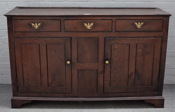 An 18th century oak dresser base, with three drawers over cupboards, on bracket feet, 151cm wide x 94cm high.