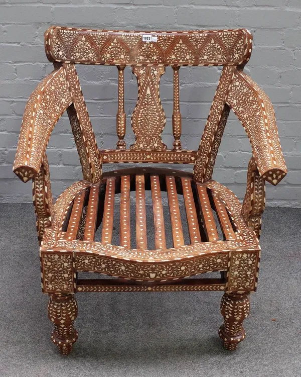 An early 20th century Indian hardwood open armchair, with extensive bone inlay, 80cm wide x 87cm high.