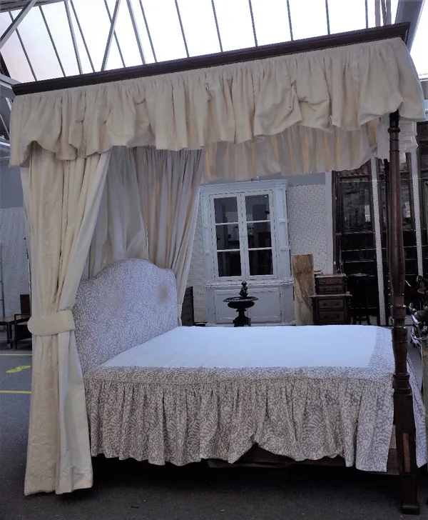 A 19th century and later mahogany four poster bed, with upholstered canopy and turned foot end supports, 190cm wide x 250cm long x 266cm high.