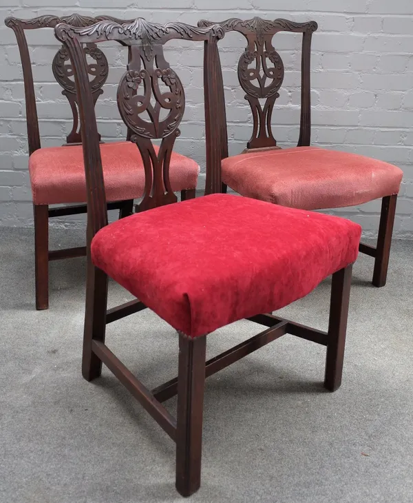 A set of three George III Chippendale style carved mahogany dining chairs, with pierced ribband vase splat back, stuff over seats, on moulded square c