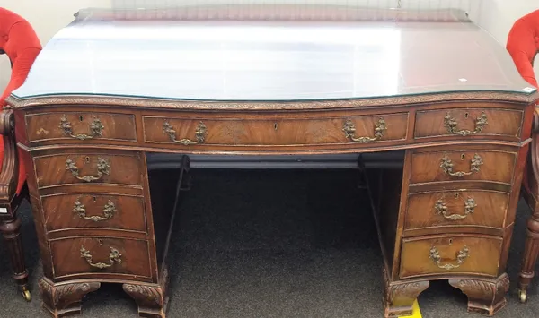 An 18th century style mahogany pedestal partners desk of serpentine outline, on scroll ogee bracket feet, 148cm wide x 94cm deep.