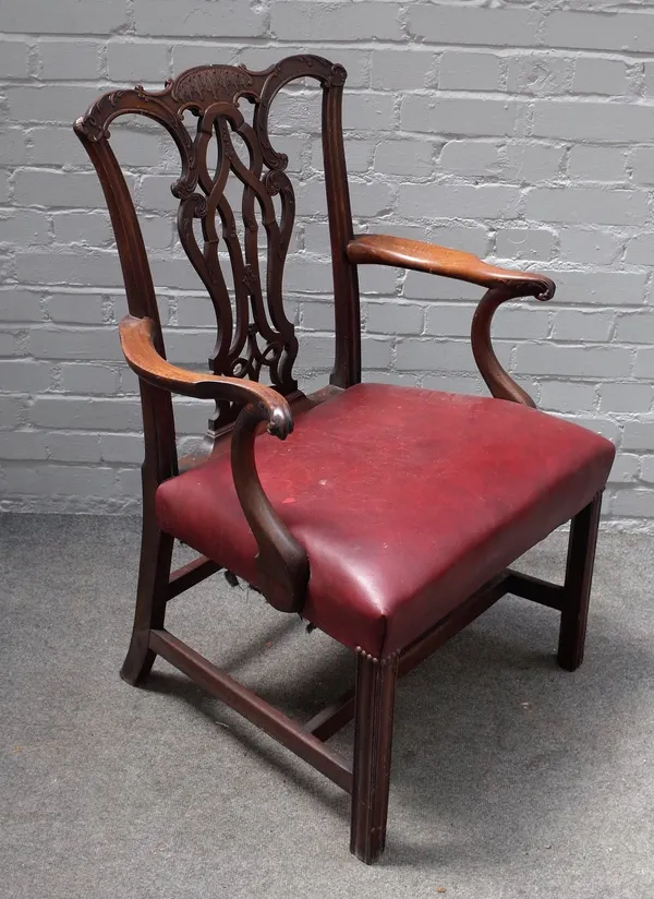 A George III Chippendale style carved mahogany openarm elbow chair, with pierced ribband vase splat back, stuff-over seat, on moulded square chamfered