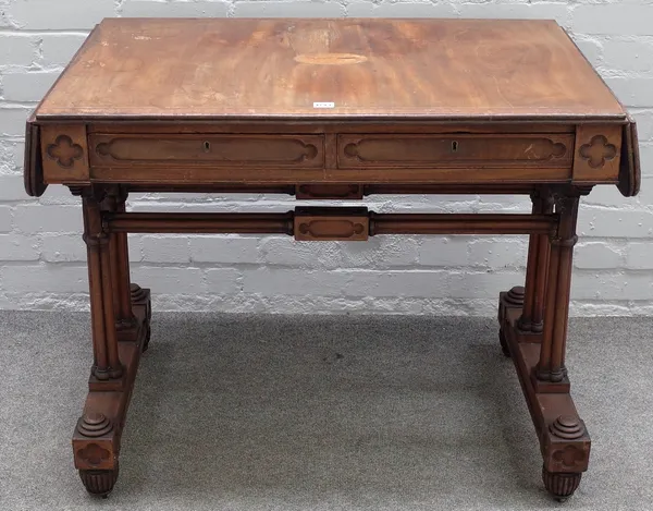 A Regency mahogany boxwood strung Gothic Revival sofa table, the top later inlaid with a conch shell oval, crossbanded and barber pole banded, with tw