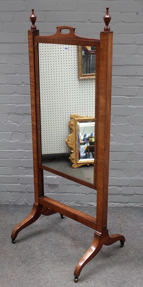 An early 19th century mahogany boxwood and ebony strung cheval mirror, the rectangular rising plate with cut-out handle, on downswept legs and castors