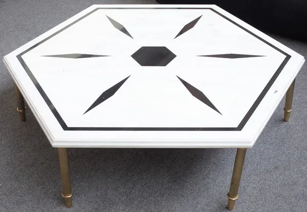 A 20th century coffee table, the inlaid octagonal marble top on six reeded brass supports, 114cm wide x 35cm high.