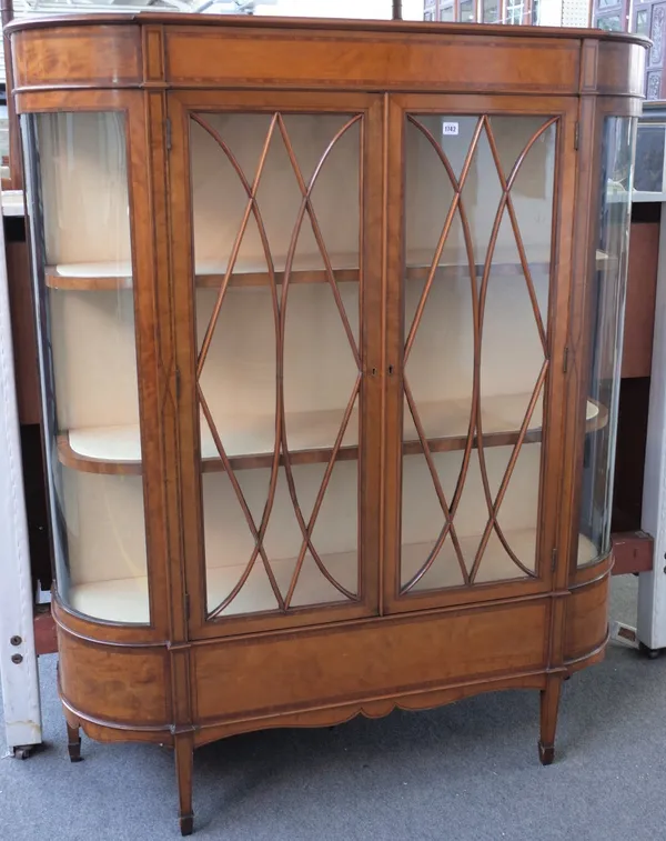 An Edwardian satinwood tulipwood crossbanded boxwood and ebony strung display cabinet, in Sheraton style, enclosed by a pair of glazed doors with glaz