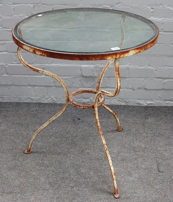 A white painted wrought iron circular French bistro table, on three shaped supports, 65cm diameter x 71cm high.