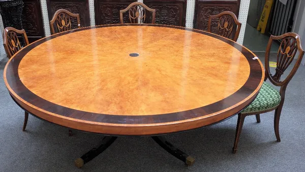 A large Regency style ebony-banded figured maple circular centre table, on  four ebonised downswept supports, 183cm diameter x 79cm high.