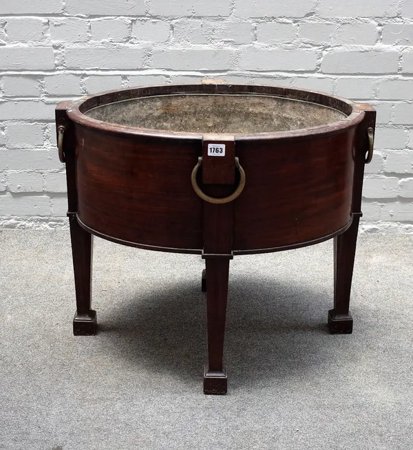 A George III style mahogany oval open wine cooler, 19th century, the outset square tapered legs headed by brass drop handles, lift-out metal liner, 68