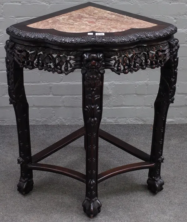 An early 20th century Chinese corner jardiniere stand, with marble inset top over carved hardwood base, 68cm wide x 81cm high.