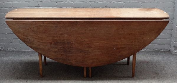 A mid-20th century teak oval drop flap wake table, on turned supports, 183cm wide x 74cm high.