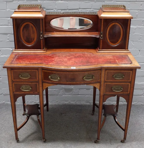 An Edwardian stainwood banded mahogany bonheur de jour, the mirrored super structure with a pair of cupboards, over five frieze drawers on tapering sq