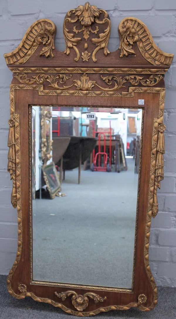 A George II style parcel gilt walnut pier glass, with swan neck cornice and bevelled plate, 55cm wide x 110cm high.