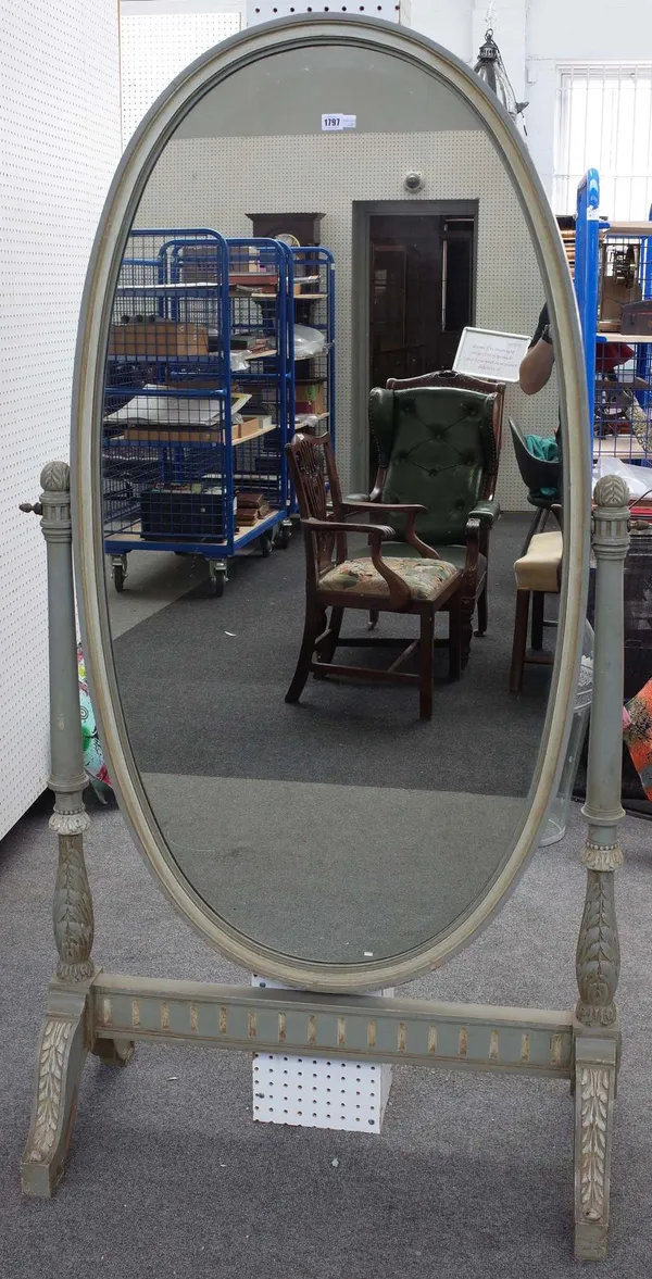 A green and cream painted oval cheval mirror, on leaf carved supports, 98cm wide x 180cm high.