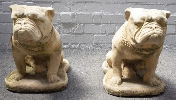 A pair of reconstituted stone figures of seated bulldogs, 30cm wdie x 40cm high.