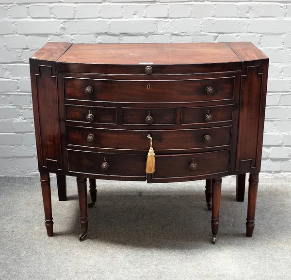 A Regency mahogany bowfront wash stand, with fitted interior on turned supports, 95cm wide x 81cm high.