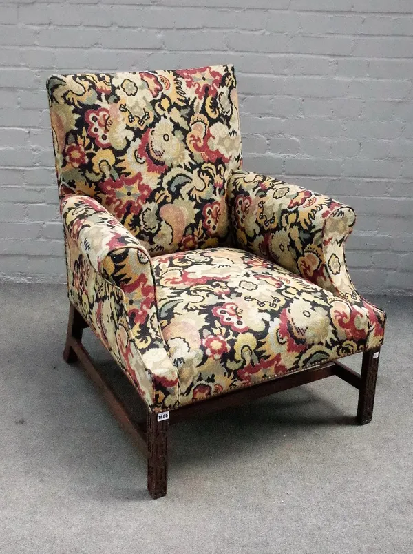 A George III mahogany framed tapestry upholstered easy armchair, on blind fret mahogany supports, 83cm wide x 93cm high.