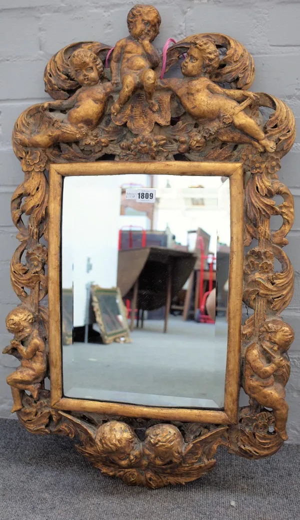 An 18th century style gilt plaster mirror, with cherub moulds and bevelled plate, 50cm wide x 83cm high.