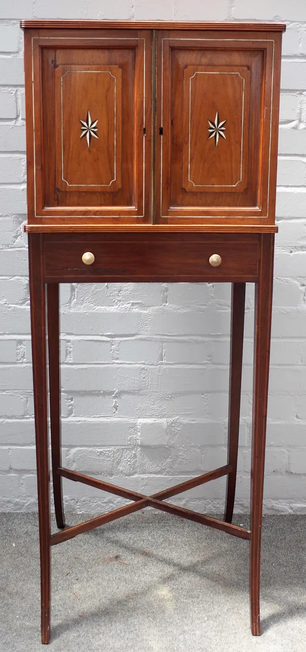 A 19th century Chinese export ivory inlaid cabinet on stand, the pair of panelled doors enclosing four long graduated drawers, the stand with four spl