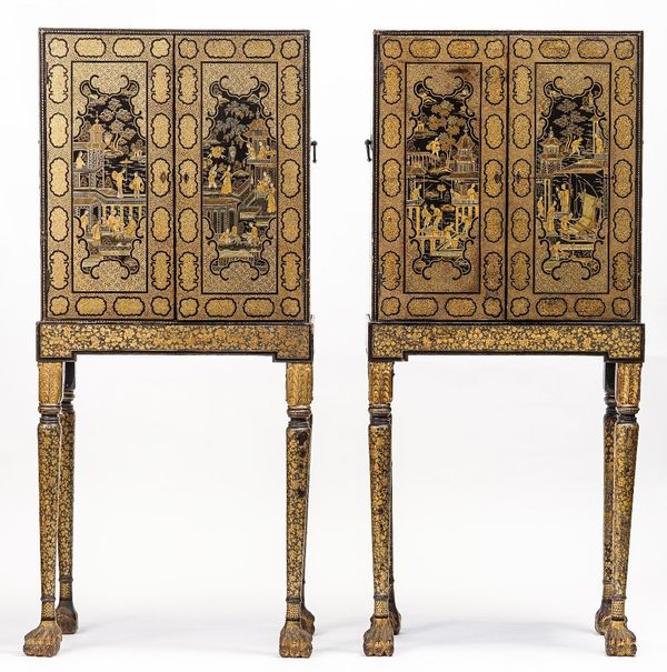 A pair of 19th century Chinese export black lacquer chinoiserie decorated cabinets on stands, each with a pair of doors enclosing a graduated eight dr