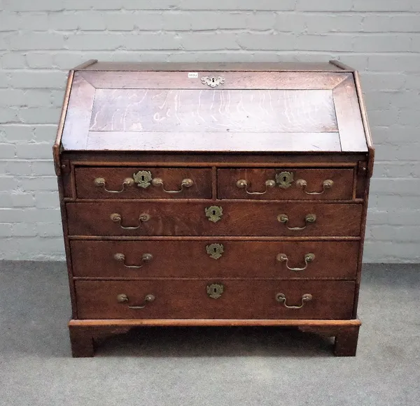 A mid-18th century oak bureau, the fitted interior over two short and three long graduated drawers on bracket feet, 98cm wide x 96cm high.   Provenanc