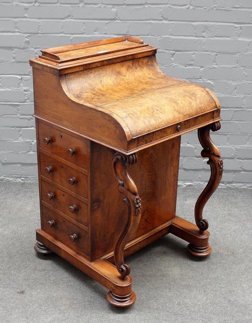 A Victorian figured walnut piano top pop up davenport, with four side drawers and scroll supports, 57cm wide x 96cm high.