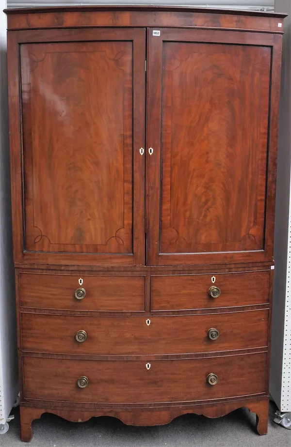 A George IV mahogany bowfront mahogany linen press, the pair of panel doors over two short and two long drawers on bracket feet, 129cm wide x 110cm hi