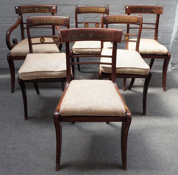 A set of seven Regency brass inlaid mahogany and rosewood dining chairs, on sabre supports to include a single carver together with four similar stain