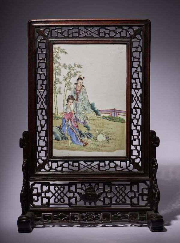 A Chinese famille-rose rectangular porcelain plaque, 20th century, painted with a woman seated on rocks with a man standing at her side in front of ba