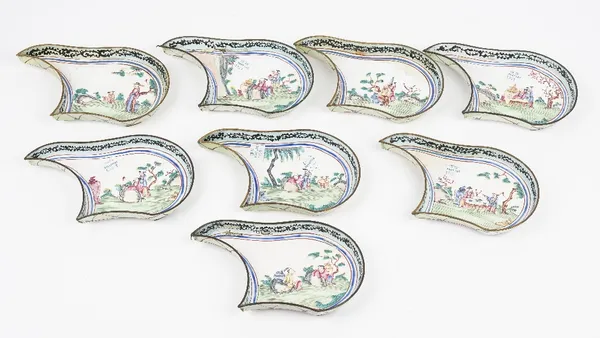 A set of eight Canton enamel famille-rose hors d'oeuvres dishes, 19th century, each painted with figures in a landscape, 18cm long. (8)