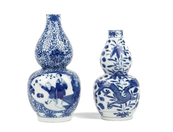 Two Chinese blue and white double-gourd vases, late 19th/early 20th century, the larger example painted with panels of a mother and child against a lo