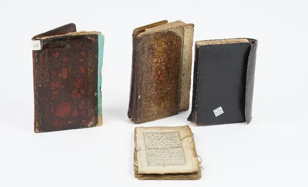 Four Islamic manuscripts, circa 19th century, including two Quran manuscripts and two prayer books, two with floral lacquer bindings. (4)