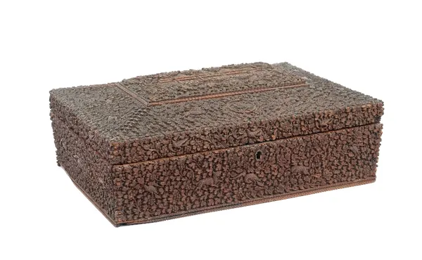 An Indian sandalwood rectangular sewing box, 19th century, the top inset with a central panel carved with buildings against a ground profusely carved