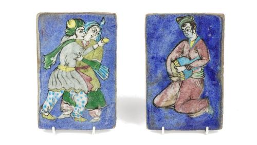 Two Qajar pottery rectangular plaques, late 19th/20th century, one moulded and painted with a figure with a drum, the other with a man and woman embra