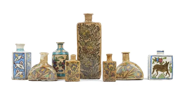 A group of eight Persian pottery flasks, 19th/20th century, of various form and size, each painted with floral decoration, sizes, 12cm-30cm high. (8)