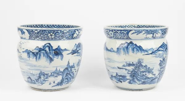 A pair of Chinese blue and white jardinieres, circa 1900, each painted on the exterior with figures and buildings in an extensive landscape, beneath a