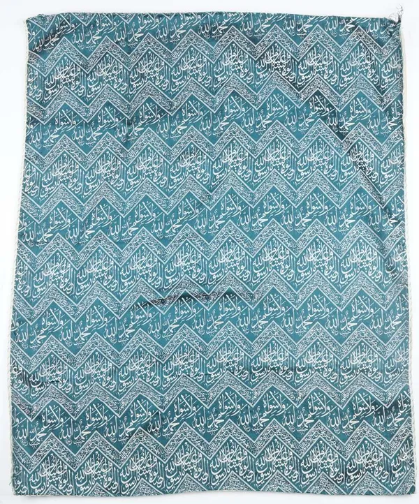 An Egyptian or Ottoman cover for a kaaba, worked with zig zag panels enclosing script against a sea green ground, 96cm x 79cm.