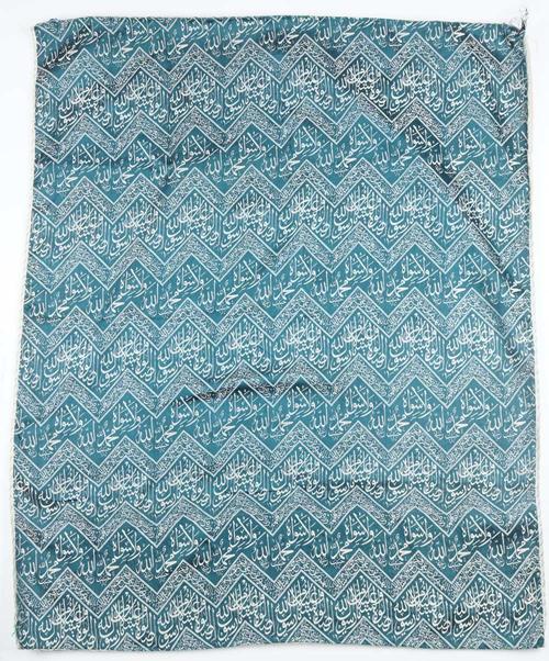 An Egyptian or Ottoman cover for a kaaba, worked with zig zag panels enclosing script against a sea green ground, 96cm x 79cm.
