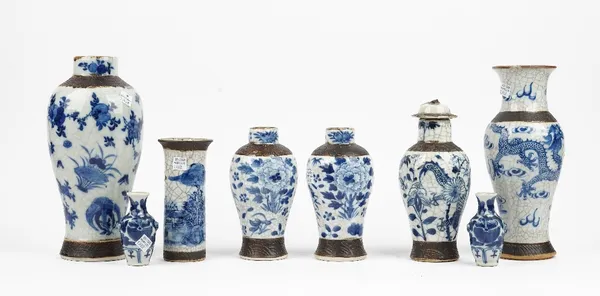 A group of Chinese blue and white crackle glazed vases, late 19th/early 20th century, including a pair of baluster vases and one cover, painted with b