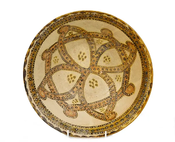 A Nishapur pottery bowl, possibly 10th century, slip decorated to the interior with an interlaced design with brown and cream dots against a cream gro