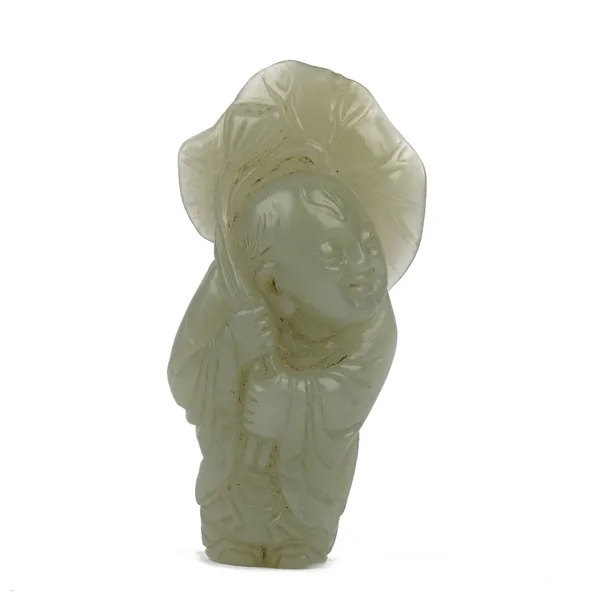 A Chinese celadon jade figure of a man, Qing dynasty, carved standing with smiling expression and carrying a large lotus flower, 6.5cm high.