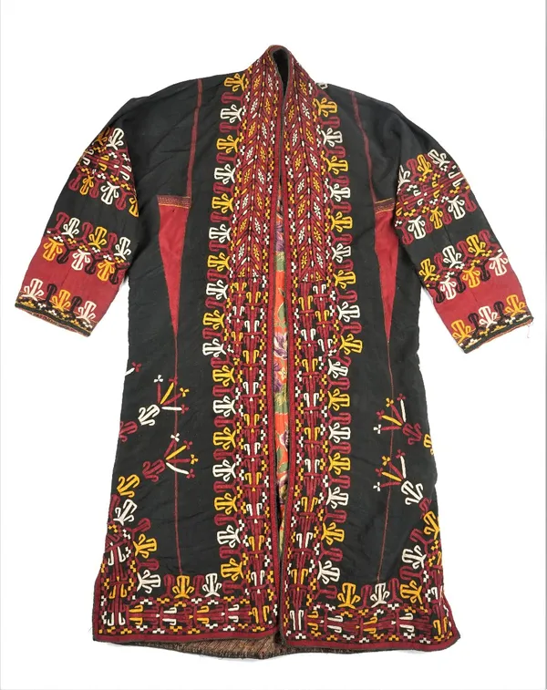 An embroidered Uzbek gown, 19th century, worked with stylised designs in purple and orange against a black ground, floral pattern lining.