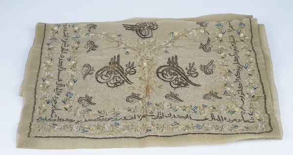 An Ottoman embroidered silk runner, 19th century, worked with tughras inside a border of script between flowers, (a.f.), 222cm long x 55cm wide.