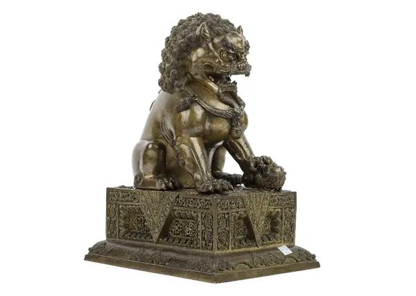 A large Chinese gilt bronze Buddhist lion, Qing dynasty, modelled seated on a separate rectangular plinth, her left front paw resting on a small cub,