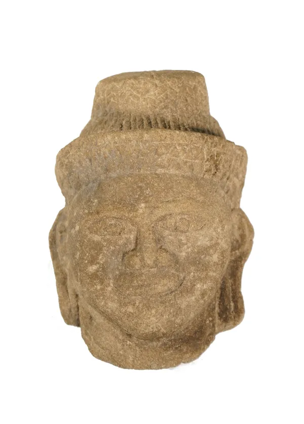 A small Cambodian head of Buddha, probably circa 12th century, carved with benevolent expression on his face, 16cm high.