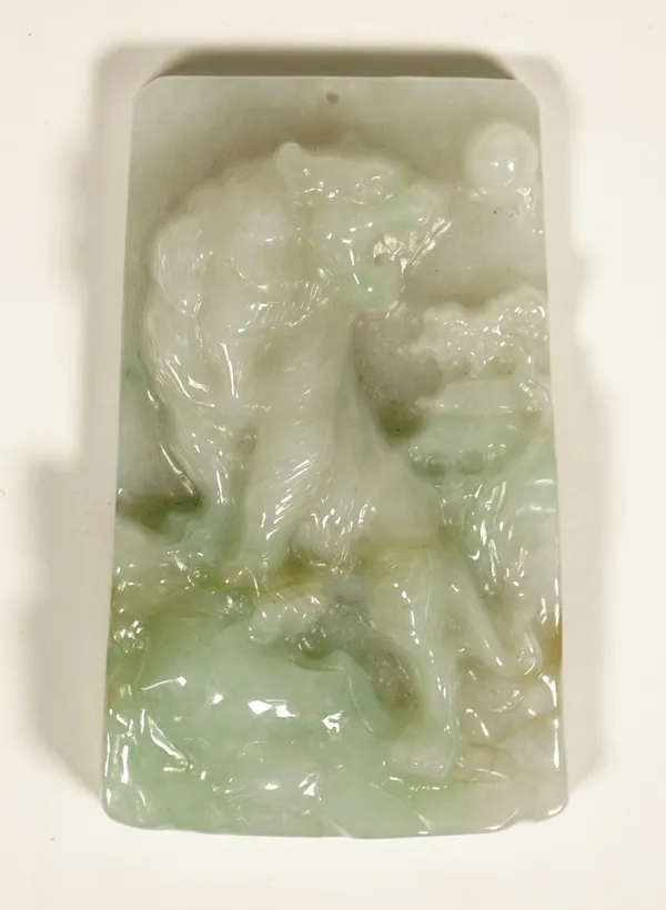 A Chinese jadeite rectangular pendant, carved in high relief with a prowling tiger, 7.75cm high.