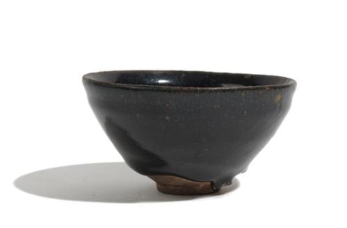 A Chinese brown glazed teabowl, Song dynasty or later, covered in a dark brown glaze with lighter brown specks, 11.5cm wide, boxed.