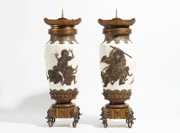 An unusual pair of Japanese Satsuma and bronze mounted vases, Meiji/Taisho period, of slender ovoid form, decorated in raised gilding, one with Kanyu