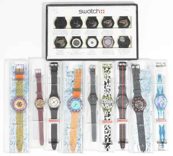 A Swatch display showing ten stages of the assembly of a Swatch wristwatch, cased and nine wristwatches, comprising; three Swatch Scuba 200, two Swatc