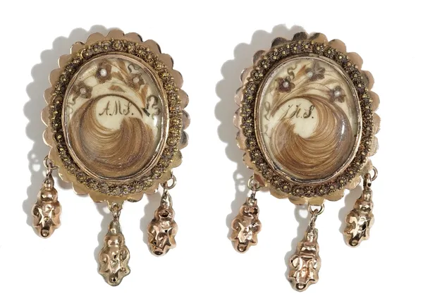 A pair of gold mourning earrings, second quarter of the 19th century, each glazed to the front with a feathered hairwork spray with initials, within a